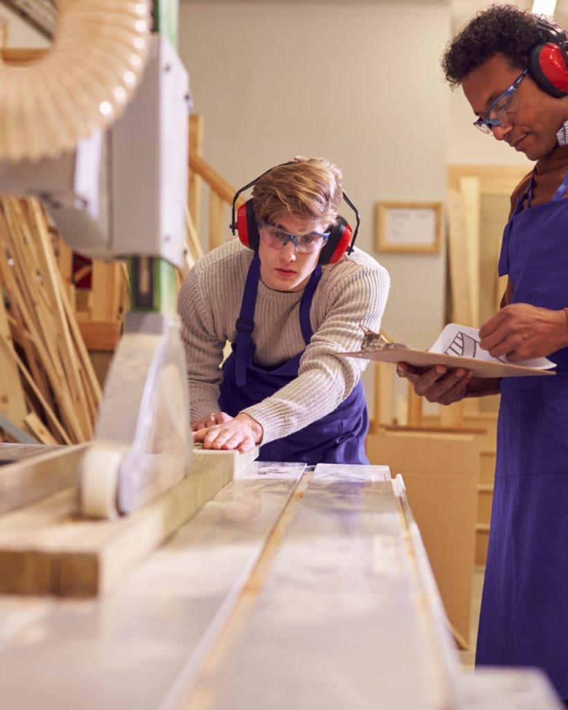 tutor-with-male-carpentry-student-in-workshop-stud-2022-02-02-04-52-24-utc